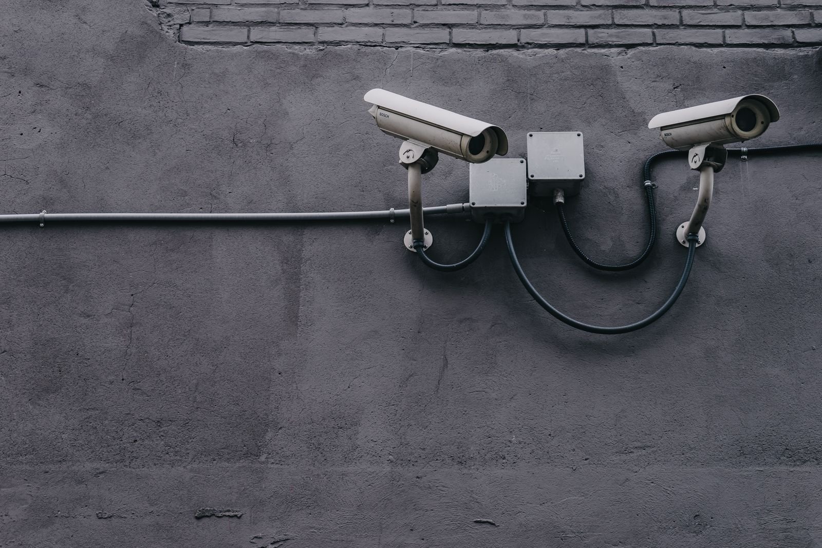 Two security cameras installed on an exterior wall